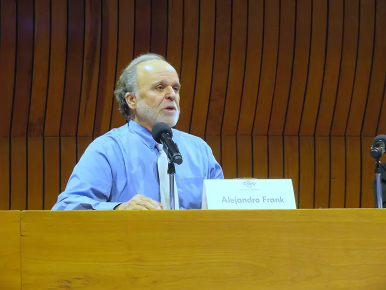 A person standing at a podium with a microphone

AI-generated content may be incorrect.